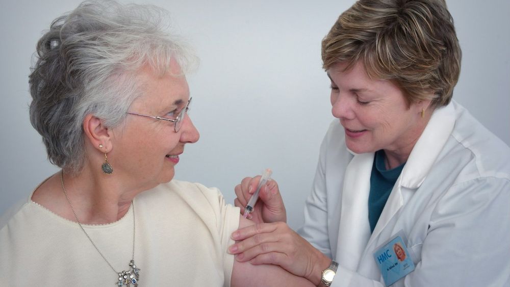 A doctor giving a patient a flu vaccination